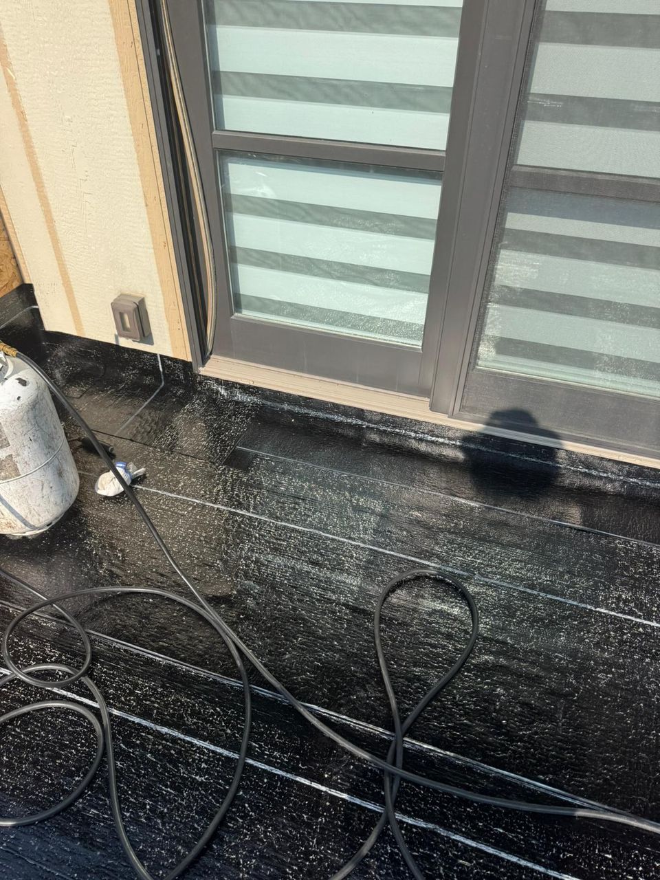 SBS membrane turned up at a patio door threshold on a balcony